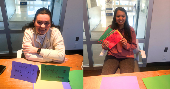 Two students with the holiday cards they wrote for families at St. Christopher’s Hospital for Children